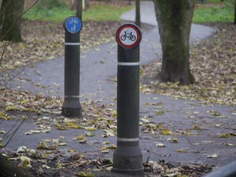 Two posts in Beddington Park. Foreground cycling prohibited, background shared for those on foot and on bicycle